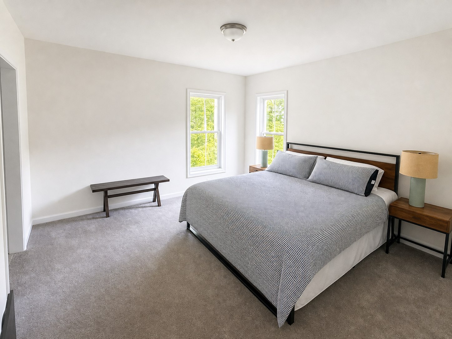 Primary king bedroom with woodland views at Wild Cherry Lodge
