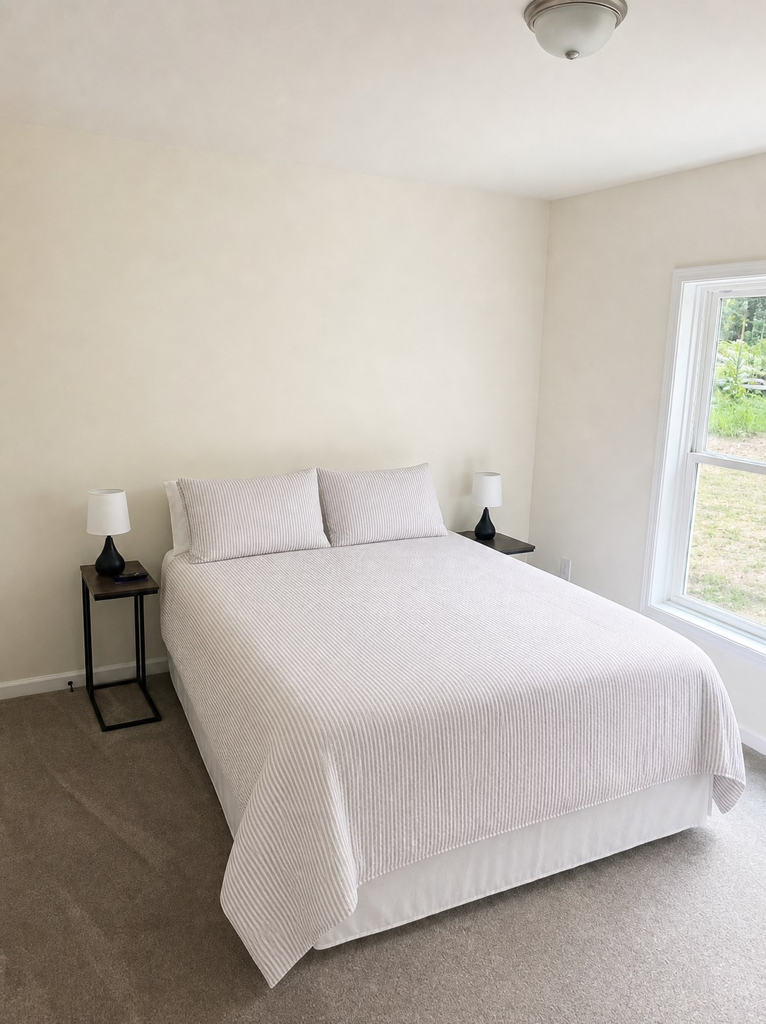 Queen bedroom with natural light at Wild Cherry Lodge